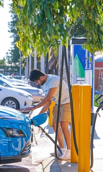 A man charges his EV electric vehicle in Geraldton